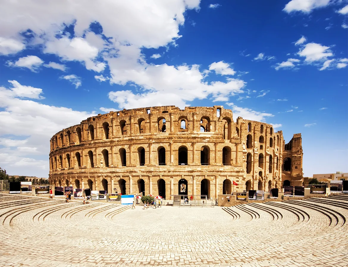 The Roman amphitheatre of El Jem under a blue sky